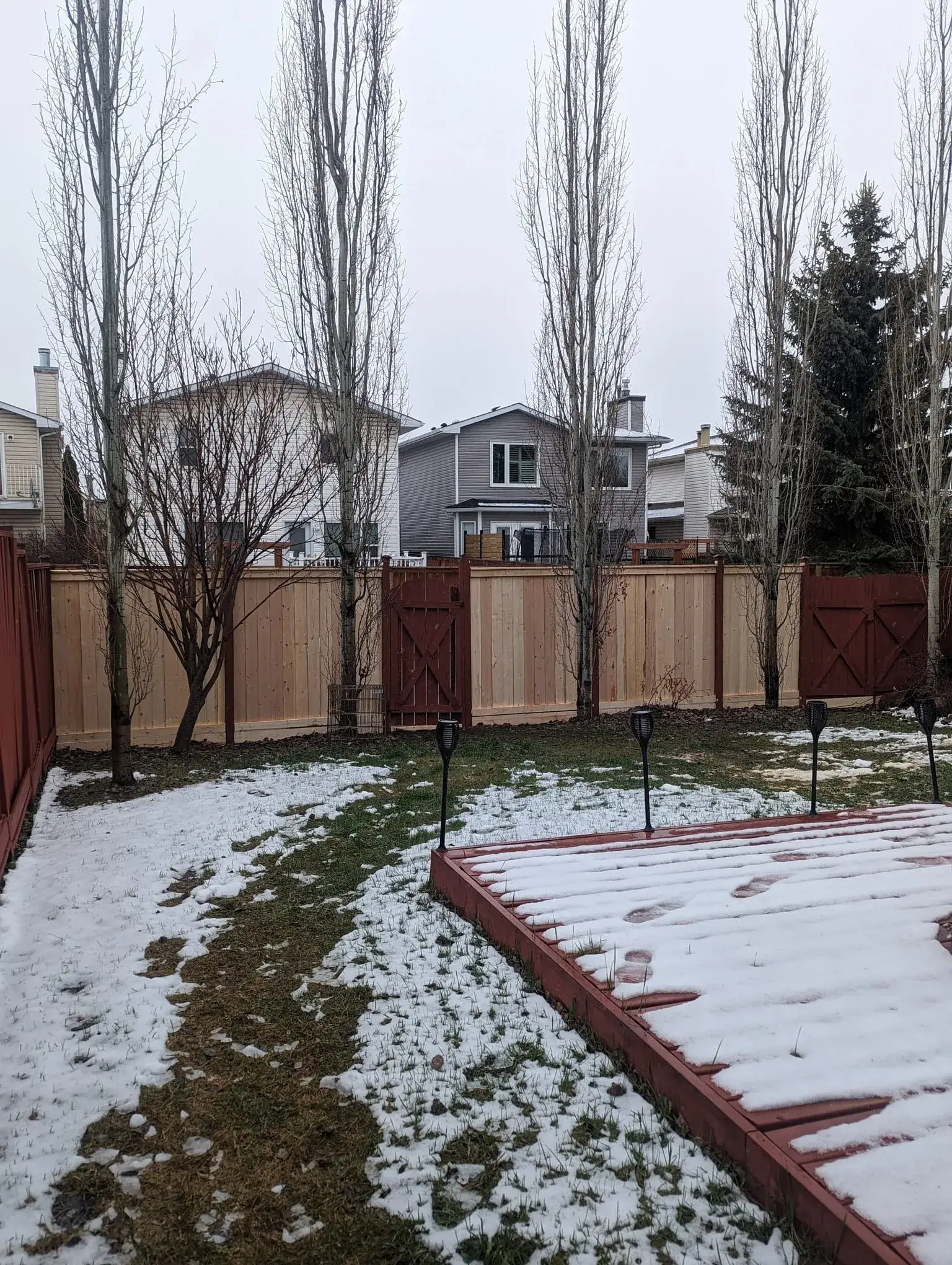 Repaired fence section blending with the original run